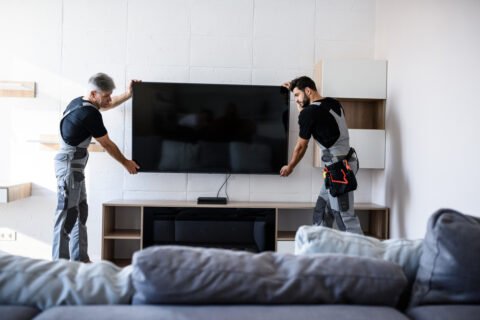 A photo of professionals from Mission Audio Visual installing a wall mounted Television (TV) in a smart home in Kelowna, BC
