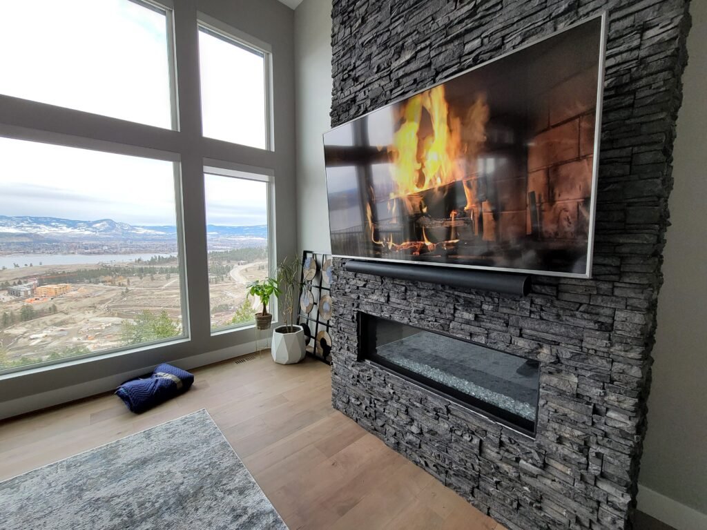 Custom Wall Mounted 4k Television and Soundbar Above a Fireplace by Mission Av in Kelowna, Bc